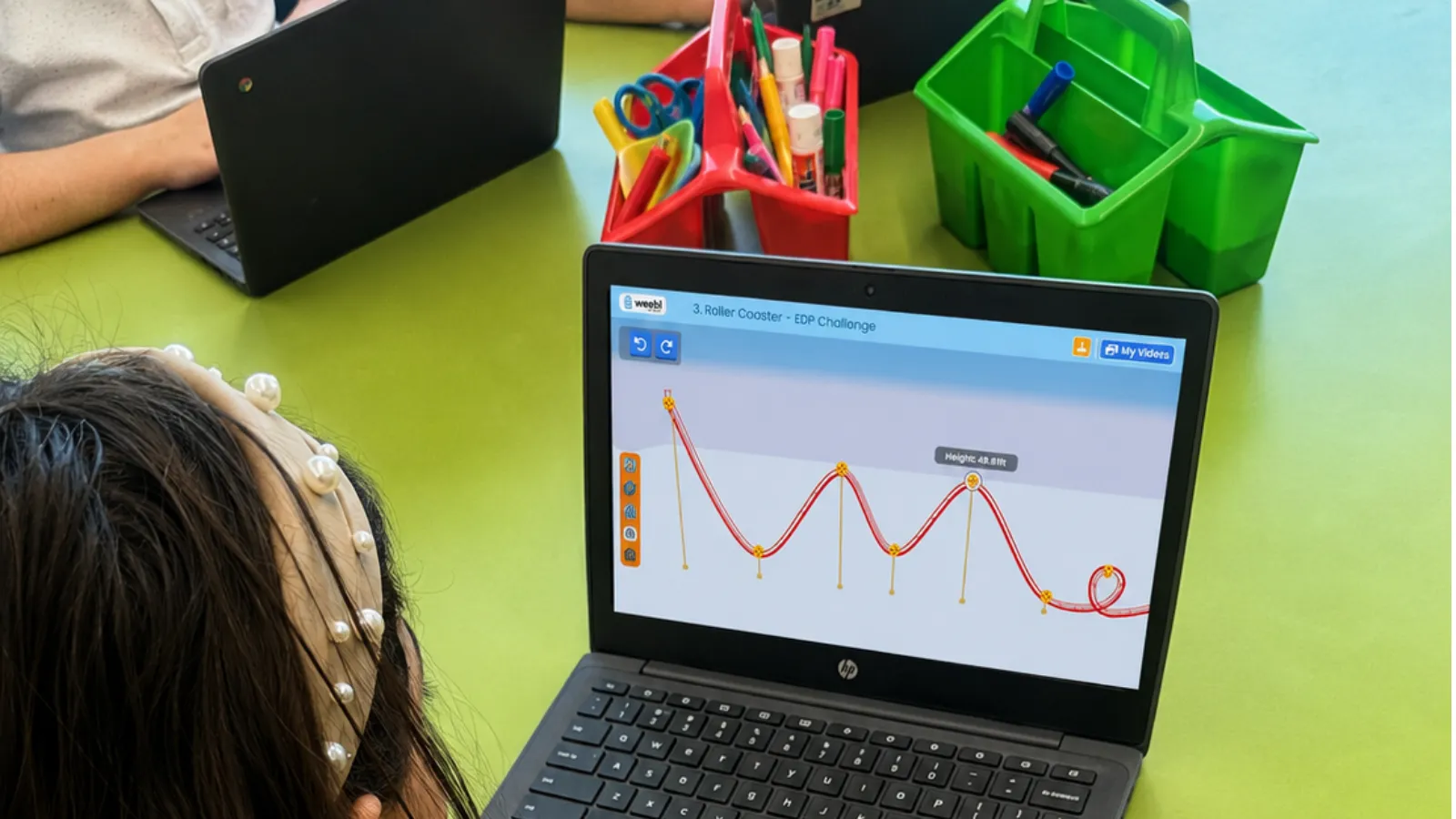 A student building a roller coaster design in the Qweebi online makerspace.