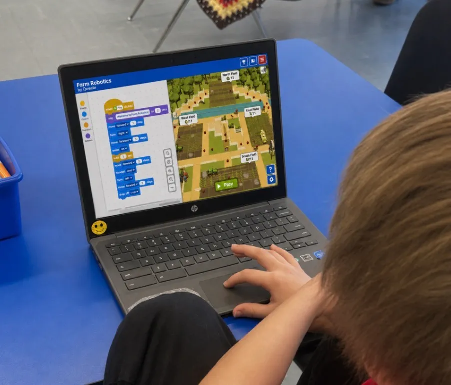 A student coding with the Farm Robotics PickBot project in the Qweebi online makerspace.