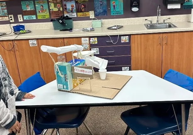 An elementary student’s physical roller coaster build made from paper.