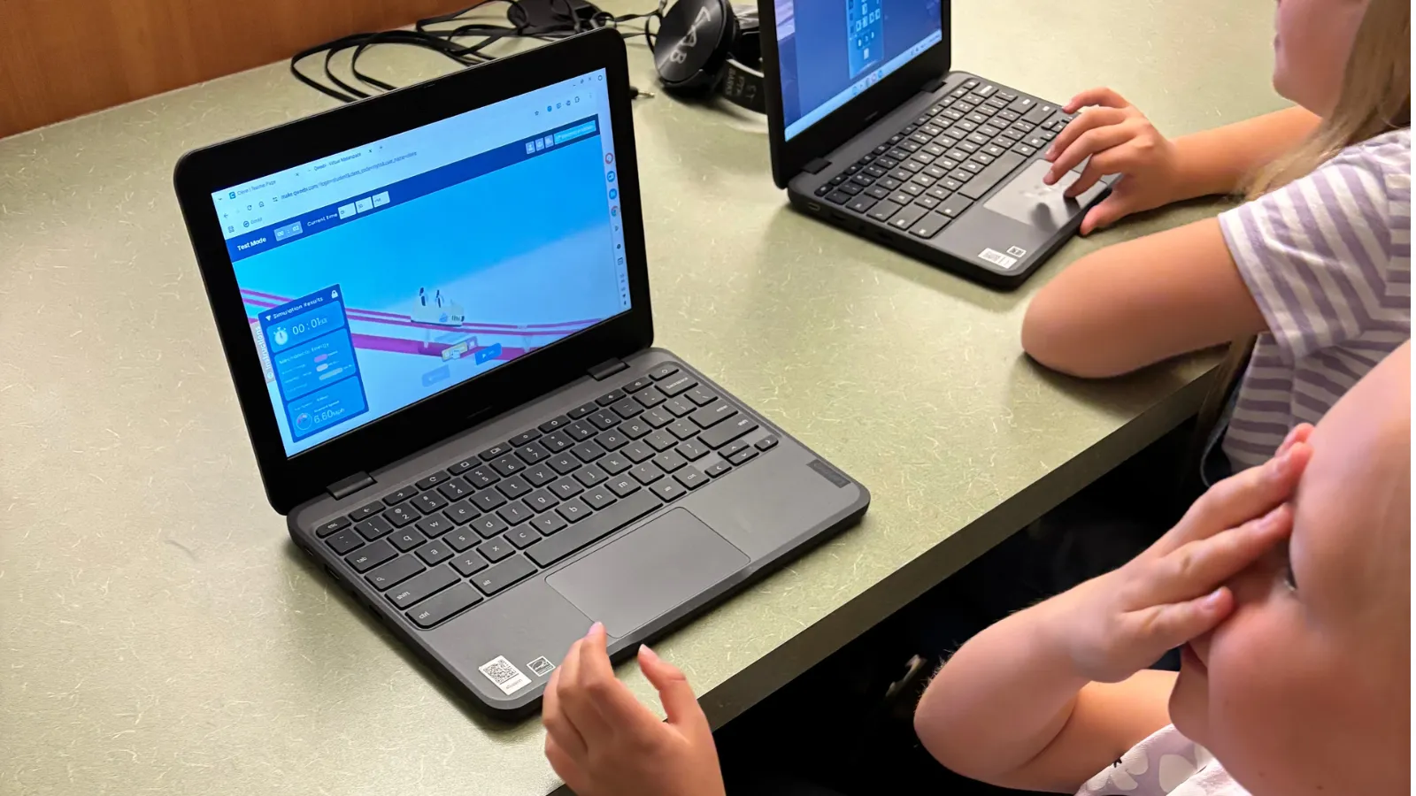 A student reacts as her Roller Coaster design runs in Qweebi's simulation mode.