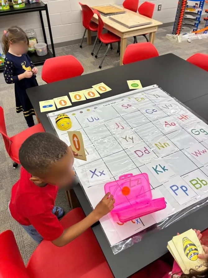 Young students working at a screen-free robotics center in Lilly Chappell’s classroom.