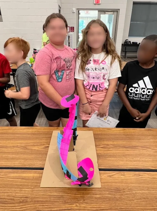 A student’s physical marble run, built after designing a Roller Coaster in Qweebi.