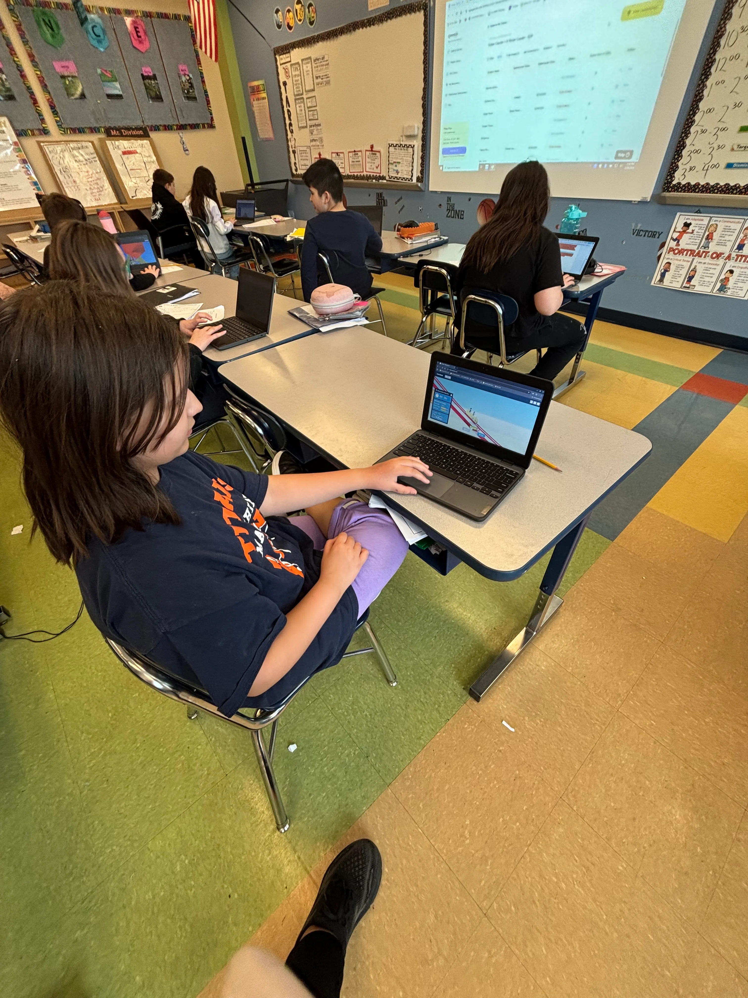 Fourth grade students building STEM projects on Chromebooks in the Qweebi online makerspace.